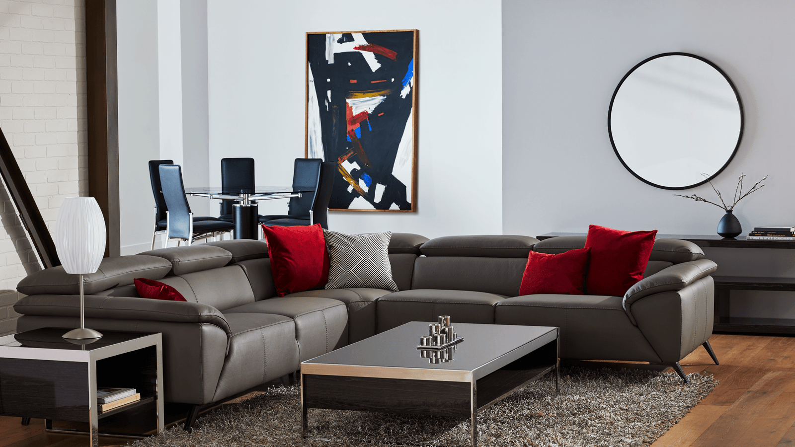 Contemporary design furniture in a living room layout with grey sectional, coffee table, and decor