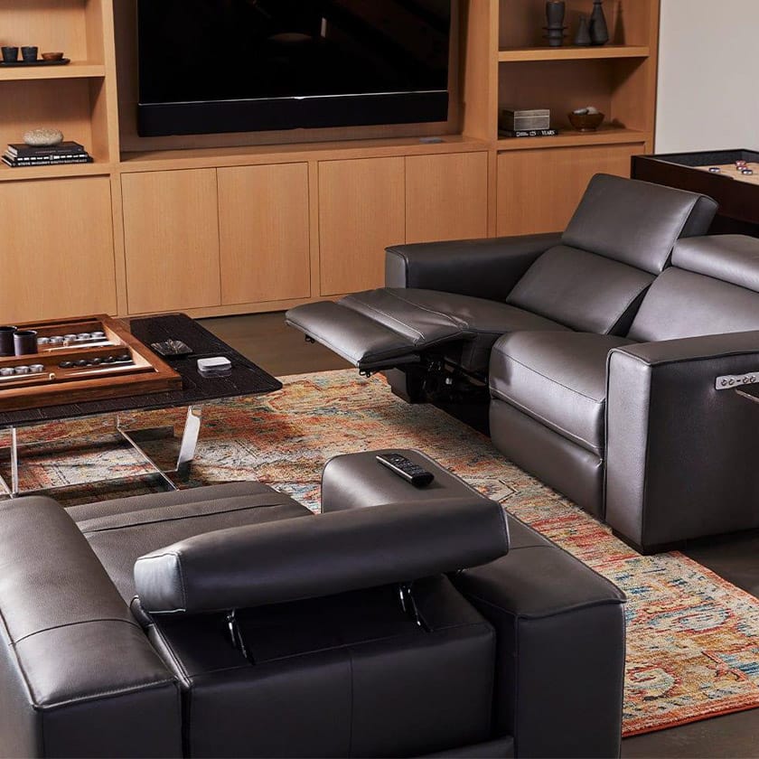 Modern living room with a gray sectional sofa, coffee table, and entertainment unit.